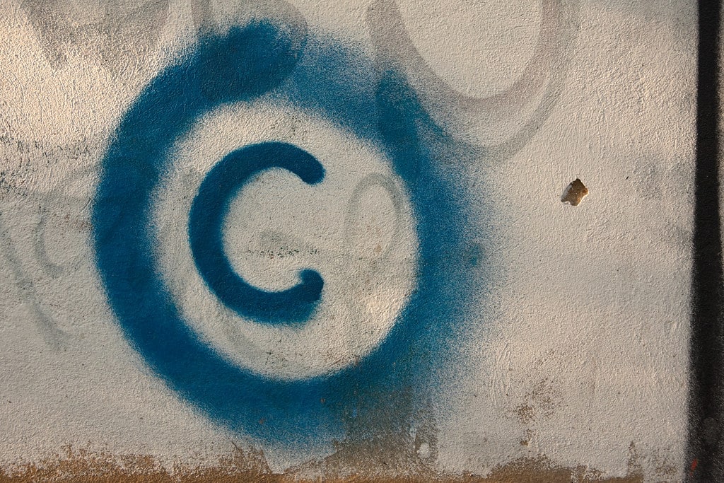 "Large copyright graffiti sign on cream colored wall" by Horia Varlan is licensed under CC BY 2.0.